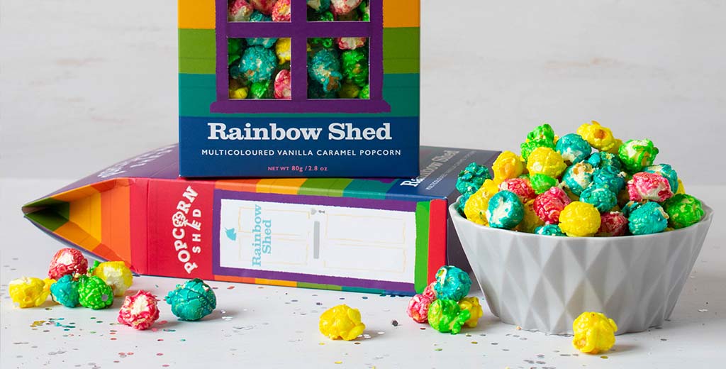 A close-up of Popcorn Shed's popular rainbow popcorn, with a bowl full of multicoloured kernels