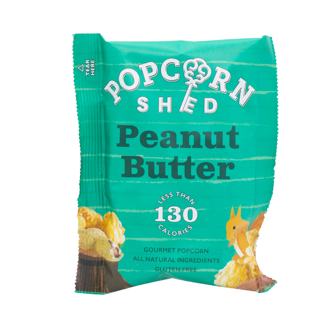Green package of Popcorn Shed Peanut Butter popcorn on a white background