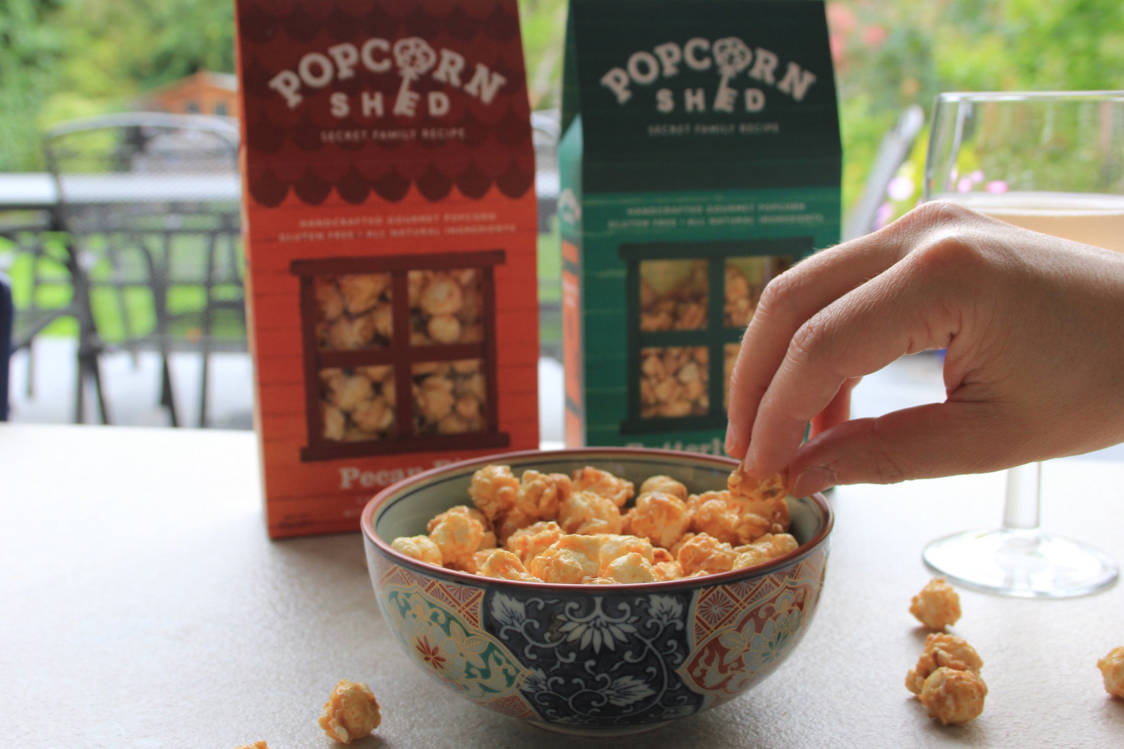A glass of wine and some gourmet popcorn